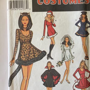 May include: A sewing pattern for five different Halloween costumes. The costumes include a leopard, a Santa, a bride, a vampire, and a devil. The pattern is from Simplicity Costumes and is size RR 14-20.