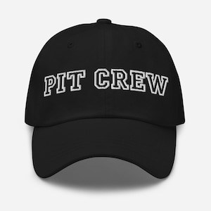 May include: Black baseball cap with white embroidered text that reads "PIT CREW".