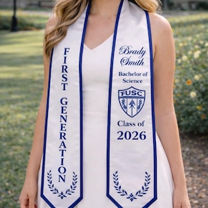 May include: A white graduation sash with blue edging and text. The sash displays "FIRST GENERATION" and "Brady Smith, Bachelor of Science, Class of 2026." A university emblem is also present.