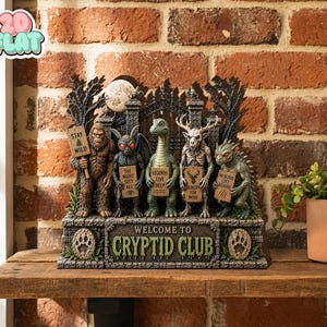 May include: A decorative figurine titled Welcome to Cryptid Club featuring five mythical creatures standing before a wrought iron gate. The figures include Bigfoot, Mothman, Nessie, a Wendigo, and a Chupacabra, each holding a sign with text.