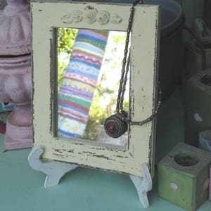 Yellow Wooden Mirror On A Stand.