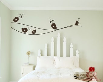 May include: A white bed with a white headboard featuring a picket fence design. The wall behind the bed has a black silhouette of birds on a branch with musical notes.