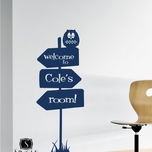 May include: A blue and white sign with an owl on top that says "welcome to Cole's room!"