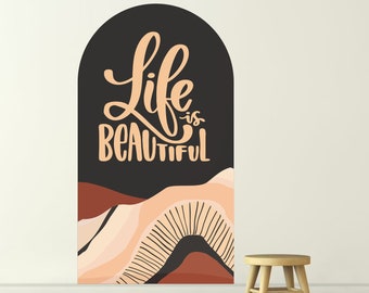 May include: A black arch-shaped wall decal with the text "Life is Beautiful" in a peachy-orange color. The decal features a stylized landscape with peach, white, and brown mountains.