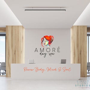 Pu&ograve; includere: Un bancone di reception bianco con un logo per una spa diurna chiamata "AMOR&Eacute; day spa" con un'immagine stilizzata di una donna con i capelli rossi. Il testo "Renew Body, Mind & Soul" &egrave; scritto sotto il logo. Il bancone si trova in un ufficio moderno con pannelli in legno e una finestra.