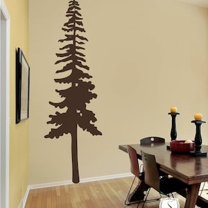 May include: A brown silhouette of a tall pine tree on a beige wall. The tree is centered on the wall and is the focal point of the image. A wooden dining table with chairs is in the foreground. The table has a dark wood finish and is set with a red bowl and candlesticks. The text "Single Stone Studios Copyright 2009" is in the lower right corner of the image.