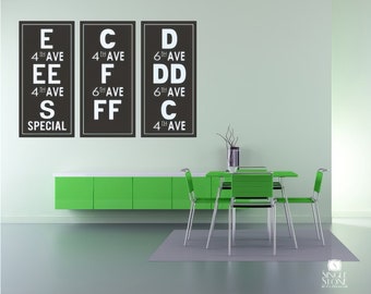 May include: Three black and white eye chart posters with the letters E, C, and D, along with the words "4th Ave", "6th Ave", and "SPECIAL". The posters are hanging on a light green wall above a green cabinet and a dining table with four chairs.