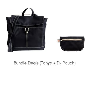 May include: A navy blue backpack with a flap closure, a top handle, and a shoulder strap, paired with a matching black pouch. Both items have white stitching and are made of a durable fabric.