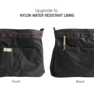 May include: Black tote bag with nylon water-resistant lining. The front of the bag has a rectangular pocket and a small square pocket with a metal label. The back of the bag has a rectangular pocket and a strap with a metal clasp.