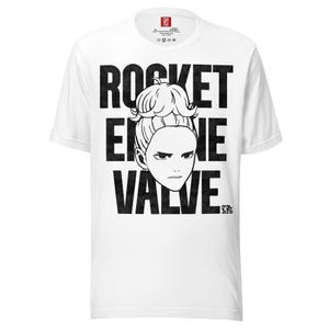 May include: White t-shirt with a black graphic design. The design features the text "ROCKET ERIE VALVE" stacked vertically, with a stylized illustration of a person's face in the center. The shirt has a crew neck and short sleeves.