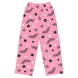 May include: Pink pyjama trousers with a black and white bat and heart pattern.