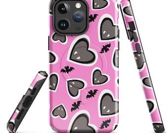 May include: A pink phone case featuring a pattern of grey hearts and black bats. The case has a black camera module and a black frame. The design is repeated on the sides. The phone case is designed to protect the phone from scratches and damage.