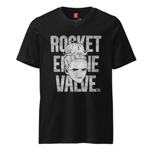 May include: Black V-neck t-shirt with a white graphic design. The design features the text "ROCKET ENGINE VALVE" stacked vertically, with a stylized illustration of a woman's face in the center. The shirt is made of a soft material.