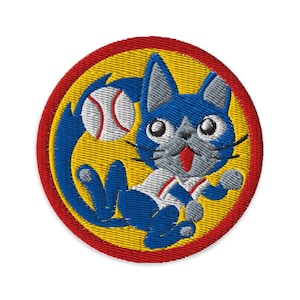 May include: Embroidered patch featuring a blue cat playing baseball. The cat is set against a yellow background, encircled by a red border. The cat is wearing a baseball uniform and holding a baseball.