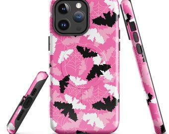 May include: A pink phone case with a Halloween design. The case displays a pattern of black and white bats, spiderwebs, and various shades of pink. The image shows the case from different angles, showcasing the design and the phone's camera.