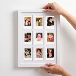 May include: A white rectangular picture frame featuring a mount with nine cutouts, each displaying a small square photograph of a child in various settings, including birthday celebrations and indoor scenes, arranged in a three-by-three grid layout.