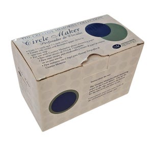 May include: A beige cardboard box for a Circle Maker, with the text "THE CREATIVE MEMORIES COLLECTION." The box has a dark blue circle and a green circle on the top. The box cuts 3.18 cm and 4.45 cm circles.