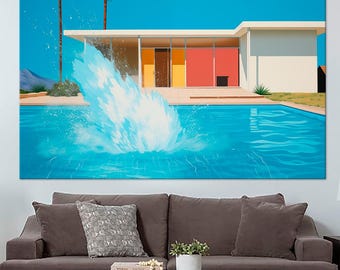 May include: A large wall art print depicting a mid-century modern house with a swimming pool. The artwork features a splash of water in the pool, palm trees, and a bright blue sky. The house has a white exterior with colorful accents.