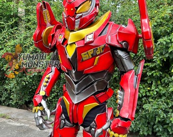 May include: A red and gold robotic costume with the word "SPIDER" on the chest. The costume has a helmet, shoulder pads, and arm guards. The costume is made of a hard material and has a metallic appearance.