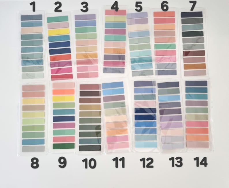 May include: A collection of fourteen color swatch sets, each containing multiple rectangular sticky notes in various shades. The color palettes range from pastel to vibrant, including blues, greens, pinks, and oranges. The sticky notes are arranged in clear plastic packaging.