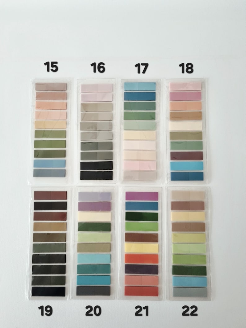 May include: A collection of color swatches, each in a clear plastic sleeve, arranged in rows and columns. The swatches display a variety of colors, including shades of pink, green, blue, and brown. Numbers 15 through 22 are printed above each column.