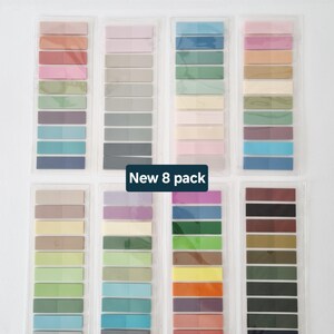 May include: Eight packs of colorful sticky notes in various shades, including pink, blue, green, and brown. Each pack contains a gradient of colors. The text "New 8 pack" is displayed on the image.