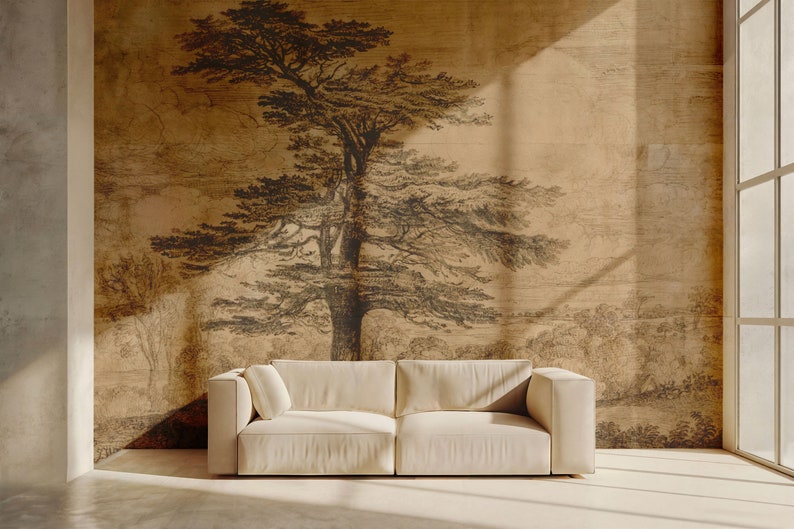 May include: A white sofa sits in front of a wall with a brown and black ink drawing of a large tree and landscape. The drawing is on a textured paper background.