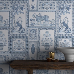 May include: Blue and white wallpaper with a repeating pattern of framed illustrations. The illustrations include tigers, peacocks, vases, and floral designs. The wallpaper is a light blue color.