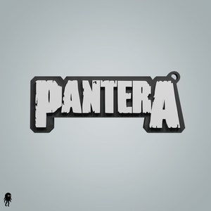 May include: A black and white 3D printed keychain with the word "PANTERA" in white letters.