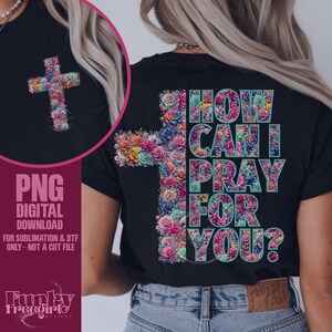 May include: Black t-shirt featuring a floral cross design on the front and back. The back of the shirt has the text "HOW CAN I PRAY FOR YOU?" in a teal and pink font. The cross is made of colorful flowers.
