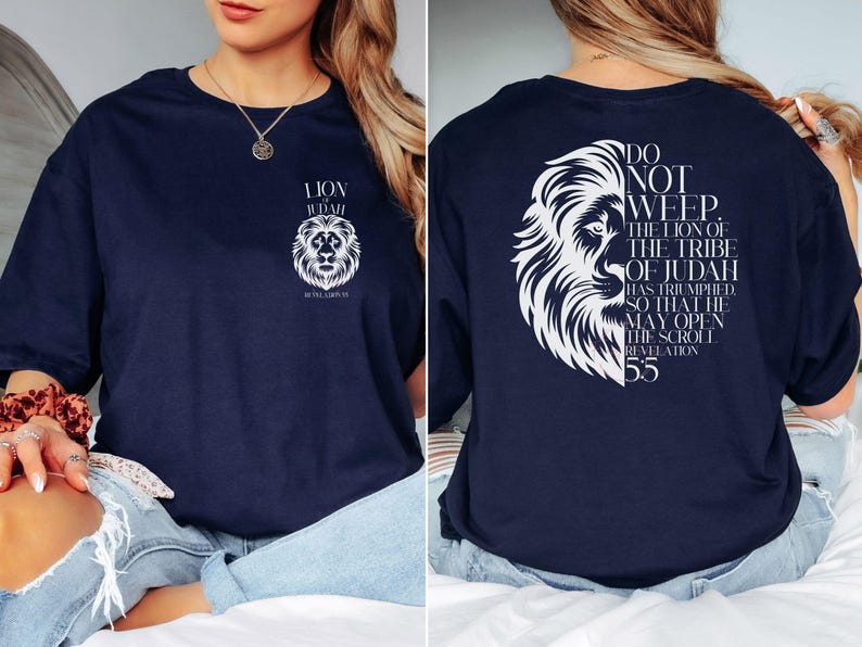 May include: Navy blue t-shirt featuring a white lion graphic with the text "LION OF JUDAH" on the front. The back of the shirt displays a lion graphic and the text "DO NOT WEEP. THE LION OF THE TRIBE OF JUDAH HAS TRIUMPHED... Revelation 5:5."