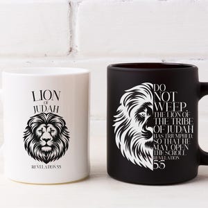 May include: Two ceramic mugs, one white and one black, each featuring a lion's head design. The white mug has the text "LION OF JUDAH" and "REVELATION 55". The black mug has the text "DO NOT WEEP. THE LION OF THE TRIBE OF JUDAH HAS TRIUMPHED. SO THAT HE MAY OPEN THE SCROLL REVELATION 55."