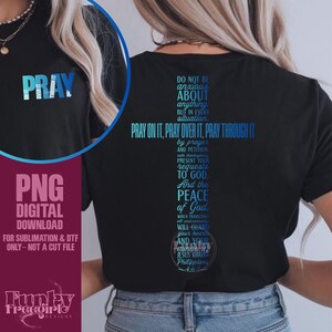 May include: Black t-shirt with a blue gradient cross design featuring the text "PRAY ON IT, PRAY OVER IT, PRAY THROUGH IT" and a Bible verse. The shirt also has the word "PRAY" in blue gradient on the front.