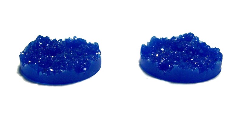 May include: Two blue resin round bases with a textured, crystal-like surface. The bases are ideal for miniature gaming.