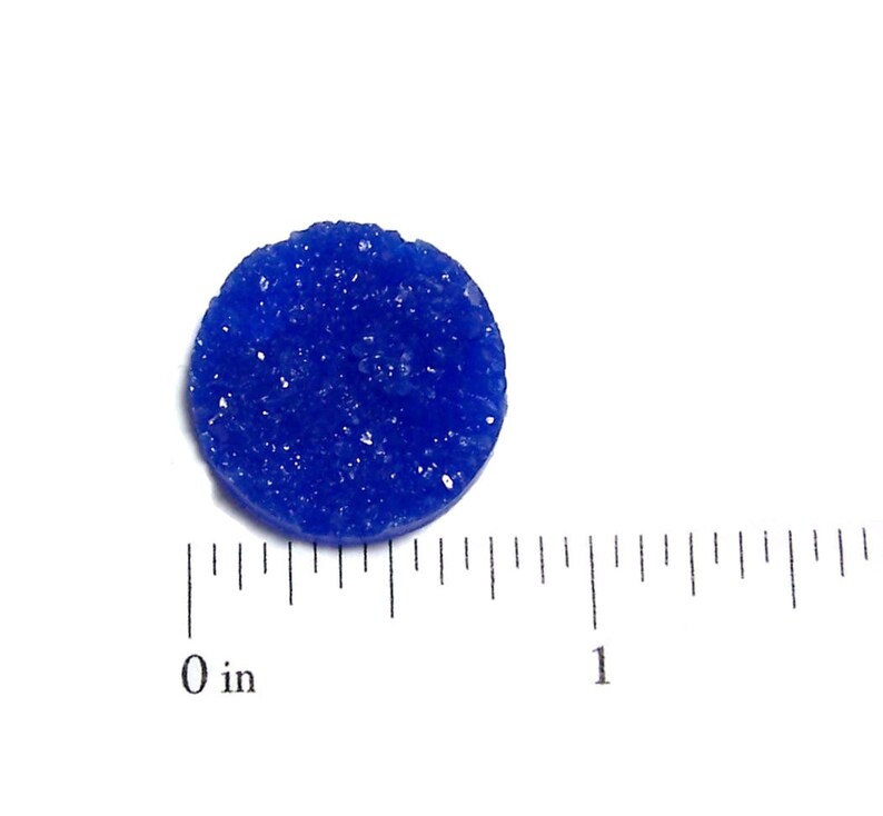 May include: A small, round, blue, textured disc. The disc is about 1 inch in diameter.