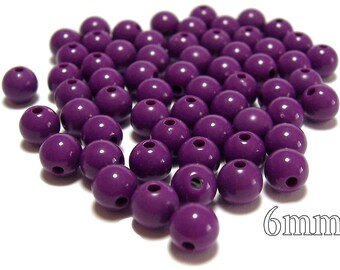 May include: A pile of 6mm purple round beads. The beads have a hole in the center.