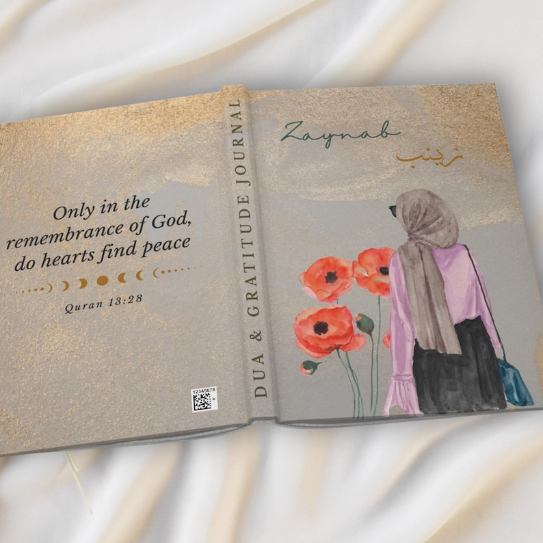 May include: Open journal with a watercolor illustration of a woman wearing a hijab, standing near red poppies. The journal cover reads "Dua & Gratitude Journal" and includes the name "Zaynab". The inside cover has a quote from the Quran.