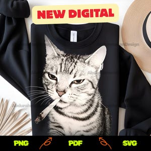 May include: Black sweatshirt featuring a detailed grayscale illustration of a cat with a cigarette in its mouth. The cat has a serious expression. The words "NEW DIGITAL" are in a red banner at the top. Below are the file type options: PNG, PDF, and SVG.