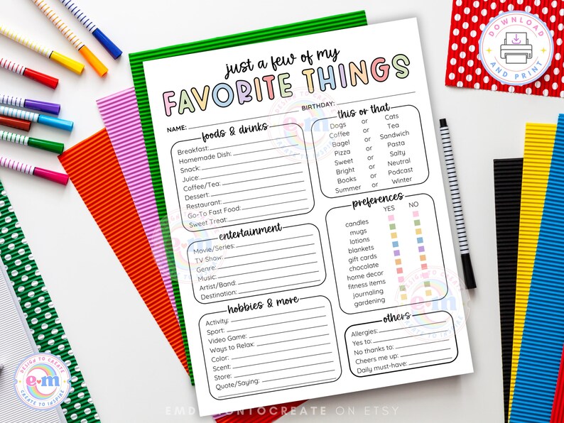 May include: A printable "Favorite Things" worksheet with a green border, featuring fill-in sections for foods, entertainment, hobbies, and preferences. The text is in a colorful, playful font. Colorful pens and paper are arranged around the worksheet.