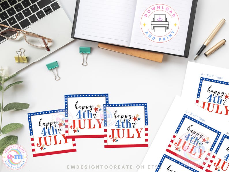 May include: White desk with a laptop, glasses, and stationery. Several square tags with a red, white, and blue design that says "Happy 4th of July". A notebook with a "Download and Print" graphic is open.