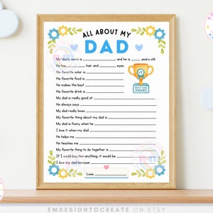 May include: A framed printable "All About My Dad" questionnaire with a light wood frame. The design features blue and yellow floral accents, a trophy graphic, and fill-in-the-blank prompts. The text includes "Best Dad Award" and "Download and Print".
