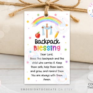 May include: A rectangular white gift tag featuring a watercolor rainbow, a wooden cross draped in blue cloth, a red apple, and a yellow pencil. The text reads: Backpack Blessing, Dear Lord, Bless this backpack and the child who carries it.