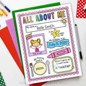 May include: A colorful "All About Me" printable worksheet with the name "Belle Smith" and the text "I am 5 years old." The worksheet includes illustrations of a camera, a girl, a crayon, a fork, a spoon, and a pizza. The text "July 5, 2020" is also visible.