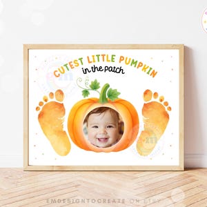May include: A rectangular print featuring the text CUTEST LITTLE PUMPKIN in the patch in orange and black lettering. A central orange pumpkin illustration contains a circular photo cutout of a smiling baby, flanked by two orange watercolor baby footprints.