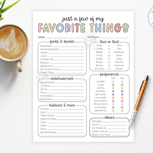 May include: A printable "Just a Few of My Favorite Things" list on white paper with colorful text. Includes sections for foods, entertainment, hobbies, and preferences. A cup of coffee and a pen are also visible.