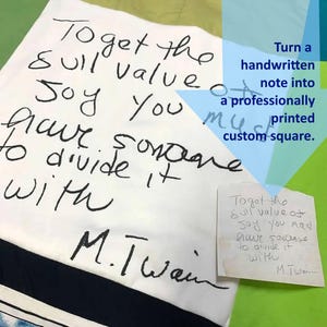 May include: A white square fabric item featuring black handwritten text that reads: To get the full value of joy you must have someone to divide it with M. Twain. A smaller paper note with the same handwritten quote is placed in the corner.