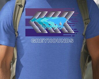 May include: A blue t-shirt with a graphic of greyhounds running in a stylized design. The design features a purple and grey color scheme with the word "GREYHOUNDS" printed below the graphic.