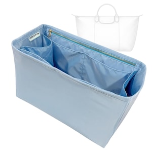 May include: A light blue handbag organizer with multiple interior pockets and a zippered closure. The organizer has a rectangular shape and is designed to fit inside a larger tote bag. The brand name "PZEOTYN" is visible on a small label.