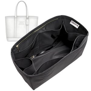 May include: Black tote bag organiser with multiple pockets and a zipped closure. The organiser is designed to fit inside a white tote bag, also visible in the image. The brand name "PZEOTYN" is printed on a white tag.