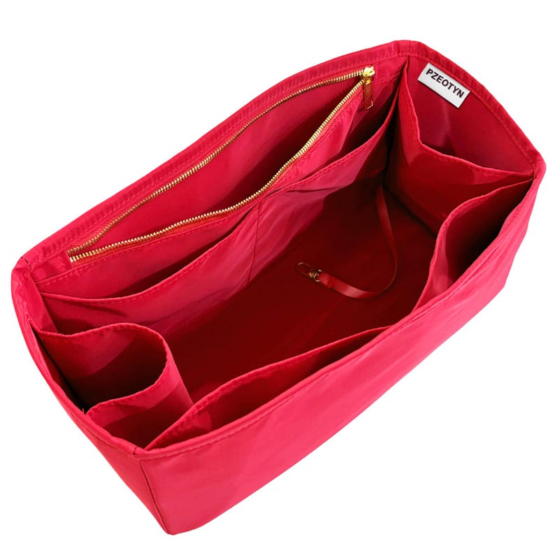 May include: A bright red handbag organizer with multiple compartments and a zippered closure. The interior features various pockets and a small strap with a clasp. The brand name "PZEOTYN" is visible on a white tag.